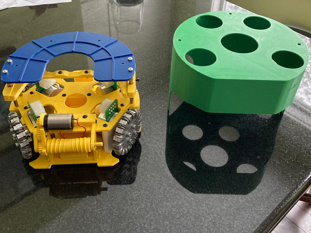 Partially assembled robot soccer prototype beside its outer shell